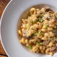 Brisket Mac 'N' Cheese · smoked beef brisket, applewood bacon, toasted bread crumbs, and scallions.