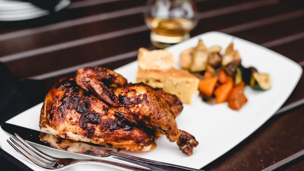 Rotisserie Chicken · half chicken, dry rubbed, slow roasted on our wood fired rotisserie. Served with cornbread & ancho-honey butter and your choice of side.