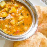 Puri Bhaji · Fluffy deep-fried bread made of unleavened wheat flour served with a very flavorful potato c...