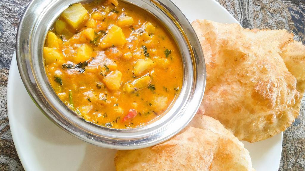 Puri Bhaji · Fluffy deep-fried bread made of unleavened wheat flour served with a very flavorful potato curry & Indian pickle on the side (Vegetarian, Vegan, Nut-Free)