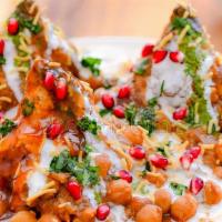 Samosa Chaat · Crushed samosa served with chickpeas, potatoes, yogurt sauce, spices, spicy cilantro-mint & ...
