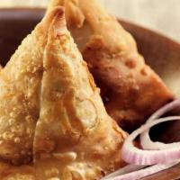 Samosa (3 Pieces) · Deep-fried pastry filled with mashed potatoes, green peas, spices & herbs served with a spic...