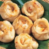 Chicken Momos · (8 pcs) Savory steamed flour dumplings filled with flavorful chicken served with a tomato-ba...