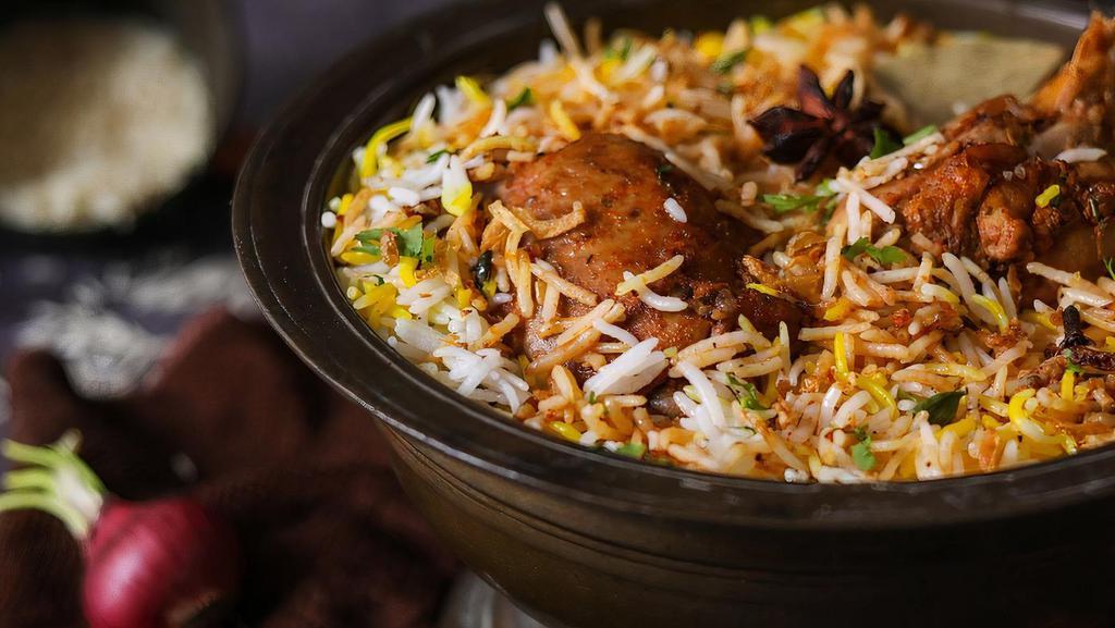 Chicken Biryani · Rice dish made with layers of boneless chicken & aromatic spices all steamed together served with raita, an herb & spice-infused yogurt sauce (Gluten-Free, Nut-Free)