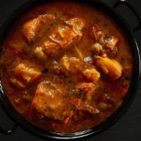 Chicken Curry · Chicken pieces stewed in an onion & tomato-based curry flavored with Indian spices & herbs s...