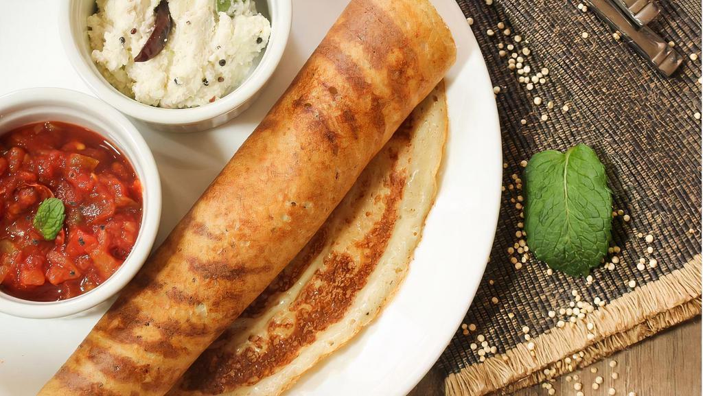 Plain Dosa · Thin savory crepe made of fermented rice & lentil batter served with white coconut chutney & mildly tangy lentil soup made with a special blend of spices (Vegetarian, Vegan, Gluten-Free, Nut-Free)
