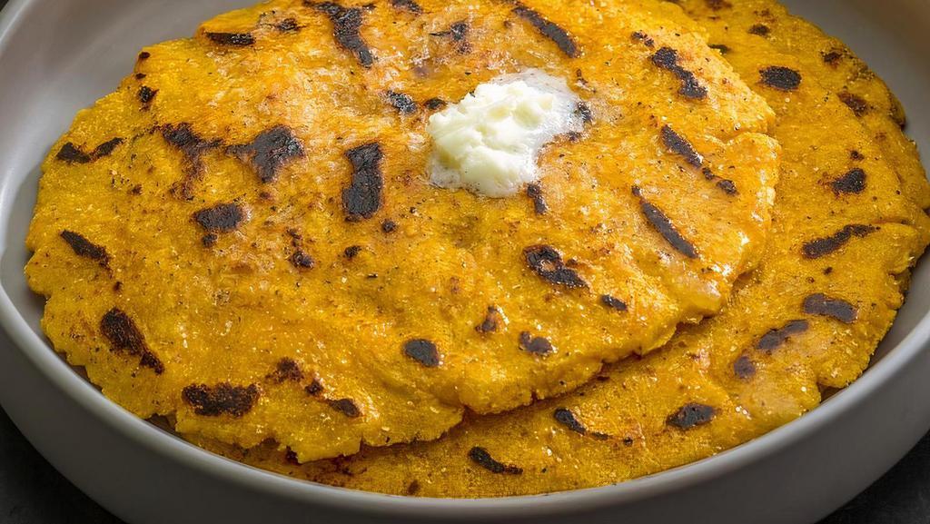Makki Ki Roti · (1pc) Unleavened cornmeal bread cooked on a skillet; vegan when served without butter on top  (Vegetarian, Gluten-Free, Nut-Free)