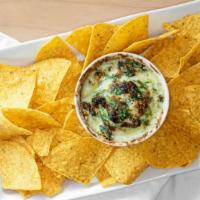 Spinach Dip · Fresh spinach with blended cheeses, garlic, salt and pepper. Served with tortilla chips.