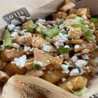 Buffalo Chicken Tots · Crispy tater tots topped with diced chicken, house-made creamy cheese sauce, green onions, b...