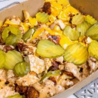 Cluck It Up Fries · Waffle fries topped with chicken bits, pickles, & a choice of cheese sauce or comeback sauce...