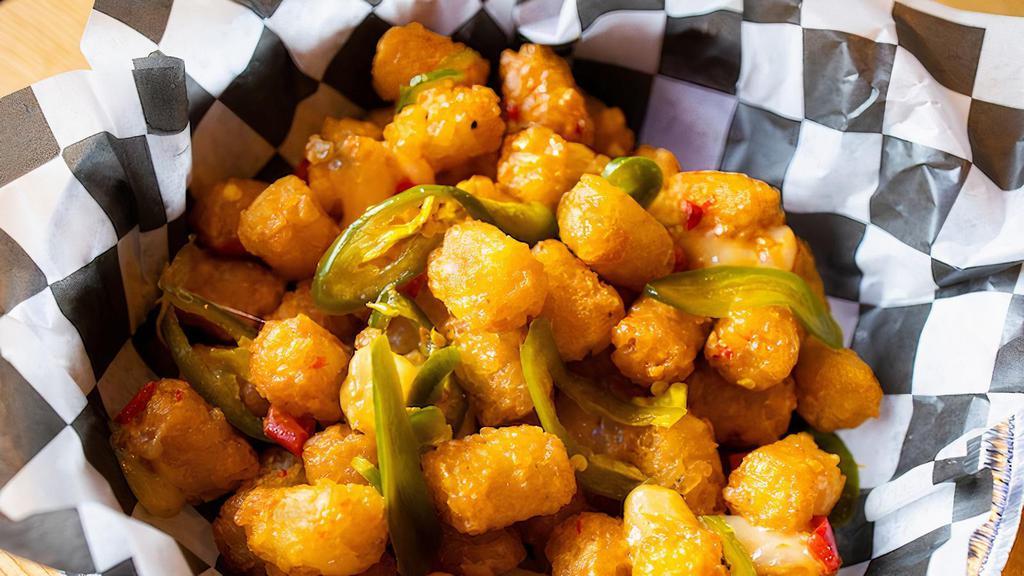 The Blutarsky · Tater tots with cheese curds, Benton's bacon, cheese sauce and bread and butter jalapeños.