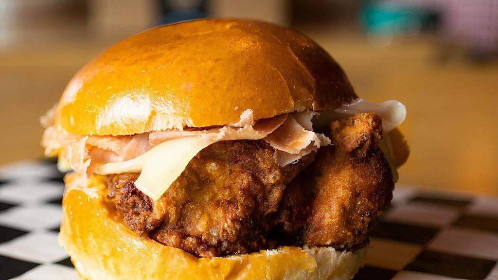 The Neidermeyer · Our version of chicken cordon bleu, our moist and tender chicken with Benton's smoked country ham, Swiss cheese and our comeback sauce on a toasted brioche bun.