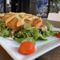 In-House Crab Cakes · Lumps of crab meat and vegetables lightly breaded and pan seared, drizzled with cilantro chi...