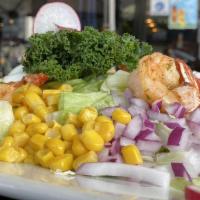 Cobb Salad · Iceberg lettuce tossed with champagne vinaigrette and topped with red onions, tomatoes, swee...