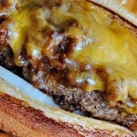 Texas Burger · Chopped BBQ brisket, cheddar cheese, onions, pickles on half pound angus beef patty.