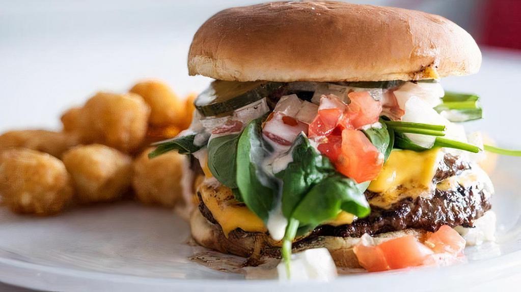 -Diner Burger- · Two ¼ pound patties on a potato roll with house pickles, spinach, tomatoes, American cheese, onion, and special sauce.