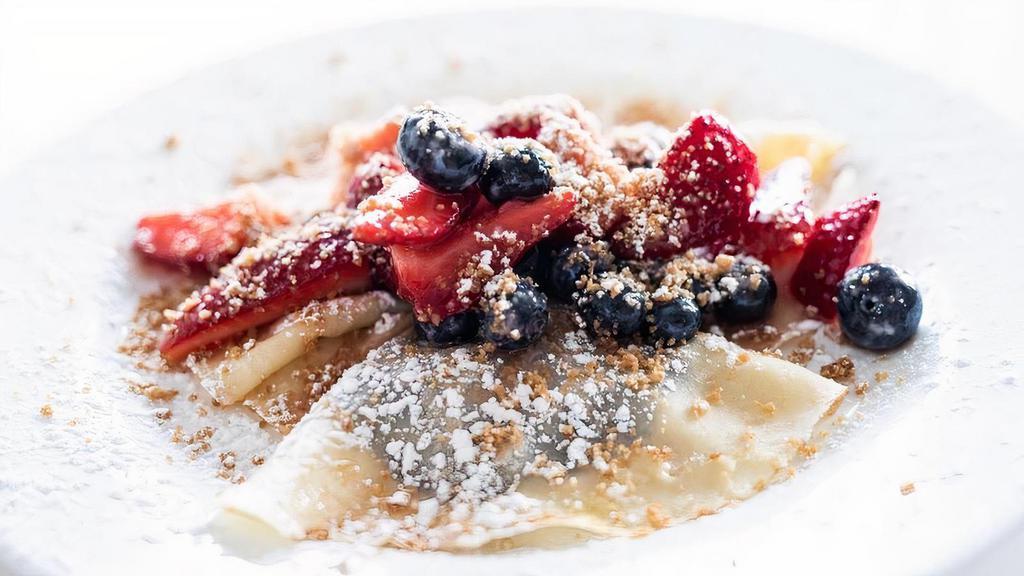 -Crepes- · Three crepes stuffed with Nutella and topped with marinated berries, walnut streusel, and powdered sugar.