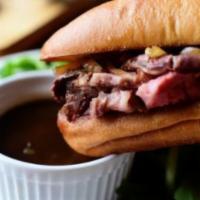The French Dip · A Chicago-style Italian beef sandwich with toasted bread melted cheese thinly sliced prime r...