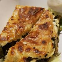 Spanakopita · A homemade spinach pie made with layers of phyllo, a filling of seasoned spinach, onions, an...