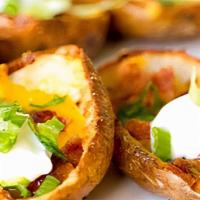 Potato Skins · Bacon, scallions, shredded cheese and sour cream.