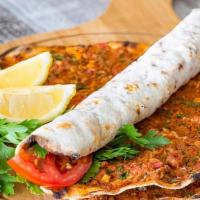 Turkish Lahmacun · Thin piece of dough topped with minced meat.