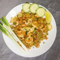 Pineapple Fried Rice · Stir-fried jasmine rice in yellow curry powder with shrimp, chicken, pineapple chunks, raisi...