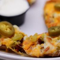 Potato Skins · Spuds loaded with diced green chiles, mixed cheese, bacon bits and pickles jalapenos. Served...