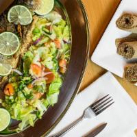 Trout Fish With Veggie · Trout fish marinated with spices sauce and fried in olive oil.