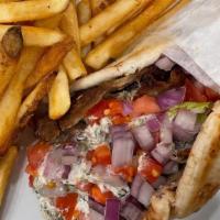 Greek Gyro · Sliced grilled gyro meat with tomato, onion and tzatziki sauce on pita bread