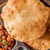 Cholay Bhature · Spicy chickpeas curry served with fried leavened flatbread.