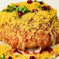 Raj Kachori · Spicy chat bowl stuffed with sprout filling served with curd, chutney, and sev.