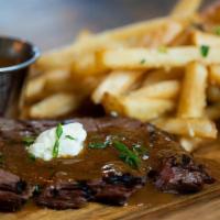 Steak Frites · 7-ounce Wagyu Skirt Steak, Truffle Fries, and Au Poivre Sauce, topped with Herb Butter