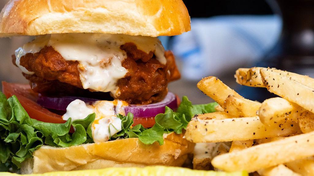 Blue Buffalo Fried Chicken Sandwich · Buttermilk-Rosemary Marinated Chicken Thigh Fried Crispy and Tossed in our Buffalo Sauce. Topped with Blue Cheese Dressing, Lettuce, Tomato, and Onion on a Toasted Brioche Roll