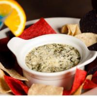 Spinach Artichoke Dip · Spinach and artichoke hearts baked in a creamy blend of cheeses and served with tri-colored ...