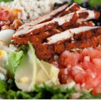 Cajun Chicken Cobb Salad · Mixed greens topped with mounds of crisp bacon, blue cheese crumbles, black olives, diced eg...