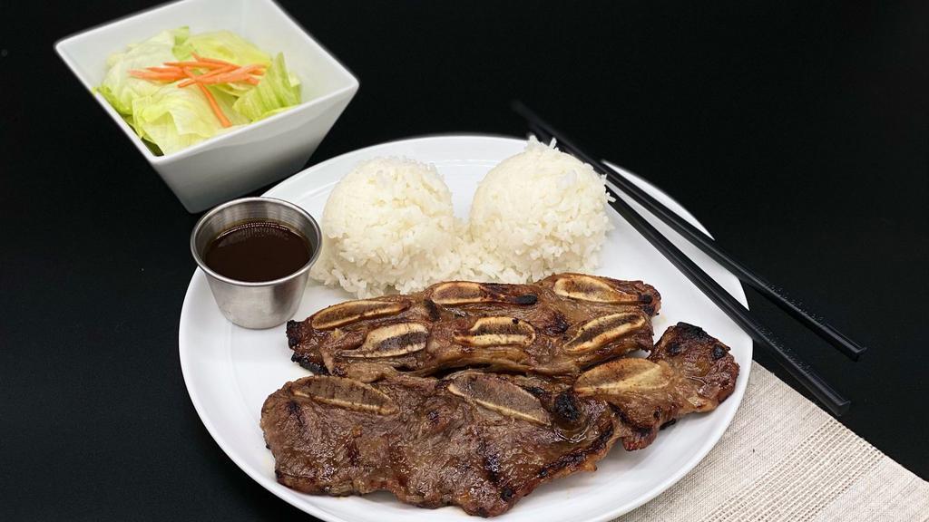 Kalbi Short Ribs · Three pieces Korean style marinated short ribs and rice. Served with side lettuce salad (poppy seed dressing).