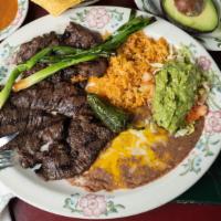 Carne Asada · Skirt streak broiled in a special way. Served with guacamole.