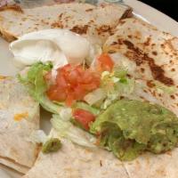 Quesadilla Asada · Two flour tortillas stuffed with melted cheese  and your choice of pollo asado or carne asad...