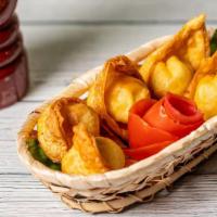 Crab Rangoon · Golden crisp crab and cream cheese wontons served with sweet and sour sauce.