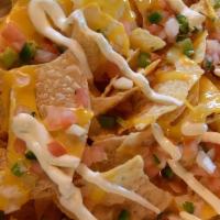Loaded Nachos · Chips topped with cheddar, pico, lettuce, onions, sour cream.
