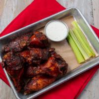 Chicken Wings · slowly smoked chicken wings, flash fried and tossed in your choice of sauce. Served with hou...