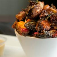Sweet & Spicy Brussel Sprouts · Crispy fried brussel sprouts tossed in  a sweet & spicy sauce. Served with ranch dressing.