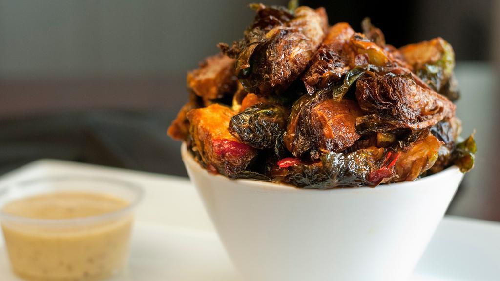 Sweet & Spicy Brussel Sprouts · Crispy fried brussel sprouts tossed in  a sweet & spicy sauce. Served with ranch dressing.
