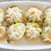 Chicken Momo · Steamed dumplings made with minced chicken, onion, garlic, ginger and spiced mix. Served wit...