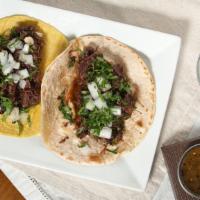 Barbacoa Taco · Shredded steamed beef, onions and cilantro.