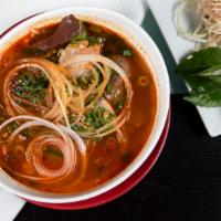 Spicy Beef Noodle Soup Bun Bo Hue · Spicy red chili and lemongrass marinated beef soup with round rice noodles, sliced beef shan...