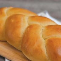 Challah Bread · Braided loaves. Unlike our other bread, we make this one with eggs, which gives it a lighter...