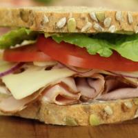 Smoked Turkey · Smoked turkey breast and Swiss cheese, topped with
thinly sliced red onion, romaine lettuce,...