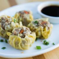 Steamed Dumplings · Steamed dumplings filled with a mix of chicken, pork & shrimp, served with a sweet sauce