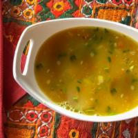 Dal Shorba Soup · Traditional soup made with split peas and lentils, subtly flavored with spices and garnished...